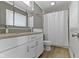 Bathroom featuring white vanity with stone countertop and shower/tub combo at 6430 N Rural St, Indianapolis, IN 46220
