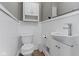 Bright and modern powder room with a sleek sink, toilet, and wainscoting at 6430 N Rural St, Indianapolis, IN 46220