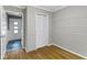 This bedroom features hardwood floors, light grey wooden paneled walls, and a closet at 6430 N Rural St, Indianapolis, IN 46220