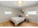 This bedroom features hardwood floors, neutral paint, and decorative light fixture at 6430 N Rural St, Indianapolis, IN 46220