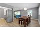 Open-concept dining area with hardwood floors and stainless steel appliances at 6430 N Rural St, Indianapolis, IN 46220