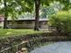 Charming single story home with stone and siding exterior, mature trees, and manicured landscaping at 6430 N Rural St, Indianapolis, IN 46220