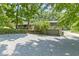 Home exterior featuring a long driveway and landscaping with mature trees at 6430 N Rural St, Indianapolis, IN 46220