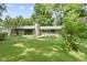 Charming single-story home featuring well-maintained landscaping, a chimney and a yellow front door at 6430 N Rural St, Indianapolis, IN 46220