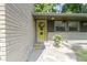 A welcoming yellow front door surrounded by a stone exterior and neatly trimmed landscaping at 6430 N Rural St, Indianapolis, IN 46220