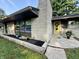 Home exterior with stone facade, yellow door and landscaped flower beds at 6430 N Rural St, Indianapolis, IN 46220