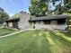 Attractive single-story home featuring a brick facade, chimney, and well-maintained lawn at 6430 N Rural St, Indianapolis, IN 46220