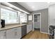 Bright modern kitchen features white cabinets, stainless steel appliances and a window at 6430 N Rural St, Indianapolis, IN 46220