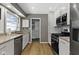 Bright modern kitchen features white cabinets, stainless steel appliances and a view to the back of the house at 6430 N Rural St, Indianapolis, IN 46220
