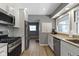 Modern kitchen features white cabinets, stainless steel appliances and woodgrain floors at 6430 N Rural St, Indianapolis, IN 46220