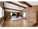Open living room featuring beamed ceilings, wood paneling, and fireplace at 6430 N Rural St, Indianapolis, IN 46220