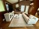Living room showcasing modern white couch, brick fireplace, and hardwood floors at 6430 N Rural St, Indianapolis, IN 46220