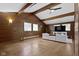 Open living room featuring beamed ceilings, wood paneling, and natural light at 6430 N Rural St, Indianapolis, IN 46220