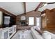 Open living room featuring beamed ceilings, fireplace, and wood paneling at 6430 N Rural St, Indianapolis, IN 46220