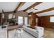 Open living room featuring beamed ceilings, fireplace, and natural light at 6430 N Rural St, Indianapolis, IN 46220