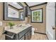 Updated bathroom featuring black vanity, framed mirror, and shower with window at 696 W Mill St, Danville, IN 46122