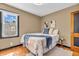 Inviting bedroom features hardwood floors and a soft, comfortable bed with plush pillows at 696 W Mill St, Danville, IN 46122