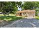 Charming home with a gravel driveway, a cozy porch, and an attached garage at 696 W Mill St, Danville, IN 46122