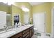 Bathroom featuring a double vanity and granite countertop and walk-in closet at 712 Disciples Way, Greenwood, IN 46143