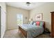 Carpeted bedroom featuring a ceiling fan, closet, and a shuttered window for natural light at 712 Disciples Way, Greenwood, IN 46143