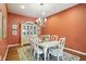 Dining room featuring an elegant chandelier, wooden floors, and stylish decor at 712 Disciples Way, Greenwood, IN 46143