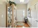 Inviting entryway featuring hardwood floors and decoratively arranged display cabinet at 712 Disciples Way, Greenwood, IN 46143
