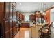 Spacious kitchen featuring dark wood cabinets and a granite-topped island with seating at 712 Disciples Way, Greenwood, IN 46143