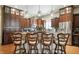Modern kitchen with a granite-topped island, stainless steel appliances, and custom lighting at 712 Disciples Way, Greenwood, IN 46143