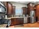Well-lit kitchen with stainless steel appliances, tiled backsplash, and wooden floors at 712 Disciples Way, Greenwood, IN 46143