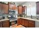 A spacious kitchen boasts granite countertops, mosaic backsplash, and stainless steel appliances at 712 Disciples Way, Greenwood, IN 46143