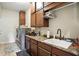 This laundry room features wooden cabinets for storage, sink, counter space, and appliances at 712 Disciples Way, Greenwood, IN 46143