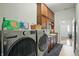 This clean laundry room is equipped with modern stainless steel appliances and wooden cabinets at 712 Disciples Way, Greenwood, IN 46143