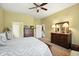 This carpeted bedroom features a ceiling fan and classic wooden furniture at 712 Disciples Way, Greenwood, IN 46143