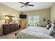 Spacious, carpeted bedroom featuring a mounted television and shuttered windows at 712 Disciples Way, Greenwood, IN 46143