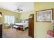 A cozy bedroom is adorned with a ceiling fan and sunny window at 712 Disciples Way, Greenwood, IN 46143