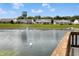 Scenic community pond view featuring a fountain, swans, and well-maintained surrounding lawns and ranch homes at 712 Disciples Way, Greenwood, IN 46143