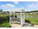 Outdoor swing facing a serene pond surrounded by lush landscaping in a lovely community at 712 Disciples Way, Greenwood, IN 46143