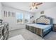 Bright bedroom with two large windows, carpet, ceiling fan, and a upholstered headboard at 7301 Deerberg Dr, Indianapolis, IN 46259