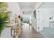 Bright entryway with wood floors, white walls, decorative table, and an open view to the living area at 7301 Deerberg Dr, Indianapolis, IN 46259