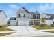 Charming two-story home features a two-car garage, stone accents, and a well-manicured front lawn at 7301 Deerberg Dr, Indianapolis, IN 46259