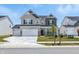 Charming two-story home features a two-car garage, stone accents, and a well-manicured front lawn at 7301 Deerberg Dr, Indianapolis, IN 46259