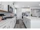 Bright kitchen featuring an oven, large island with seating and wood floors at 7301 Deerberg Dr, Indianapolis, IN 46259
