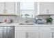 Bright kitchen featuring a stainless steel sink with modern countertops at 7301 Deerberg Dr, Indianapolis, IN 46259