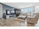 Spacious living room featuring a fireplace, large TV, hardwood floors, and comfortable grey sofas at 7301 Deerberg Dr, Indianapolis, IN 46259