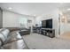 Spacious living room features a leather couch, TV, desk area, and neutral carpet at 7301 Deerberg Dr, Indianapolis, IN 46259