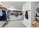 Large walk-in closet with extensive shelving, hanging racks, and carpeted floor at 7301 Deerberg Dr, Indianapolis, IN 46259