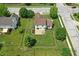 Birds-eye view of home featuring landscaped backyard, fire pit, patio, and wooden fence, nestled in a neighborhood at 8835 Harrison Pkwy, Fishers, IN 46038