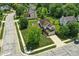 Aerial view of home surrounded by mature trees, featuring a spacious driveway, and well-kept lawn at 8835 Harrison Pkwy, Fishers, IN 46038