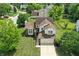 Aerial view of a home with a well-manicured lawn, mature trees, and a charming backyard patio at 8835 Harrison Pkwy, Fishers, IN 46038