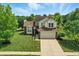 Aerial shot of a two-story home with a well-maintained lawn and a spacious driveway, surrounded by lush trees at 8835 Harrison Pkwy, Fishers, IN 46038